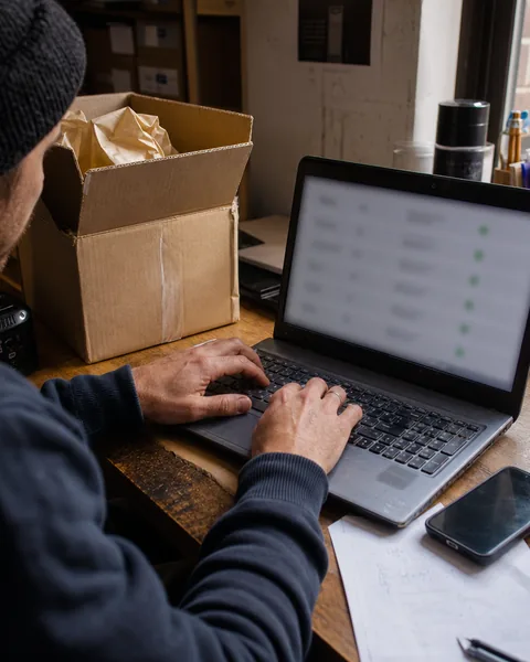 Developer checking server events on a laptop and a second screen